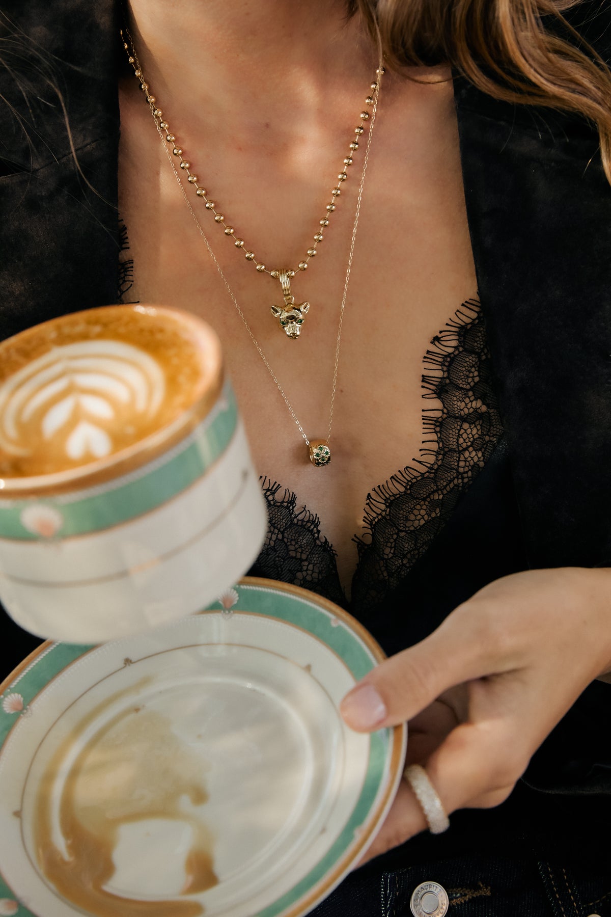 Model wearing gold Panther Charm on Amelia necklace, Nora chain with Celeste Slider, and Vivienne ring.