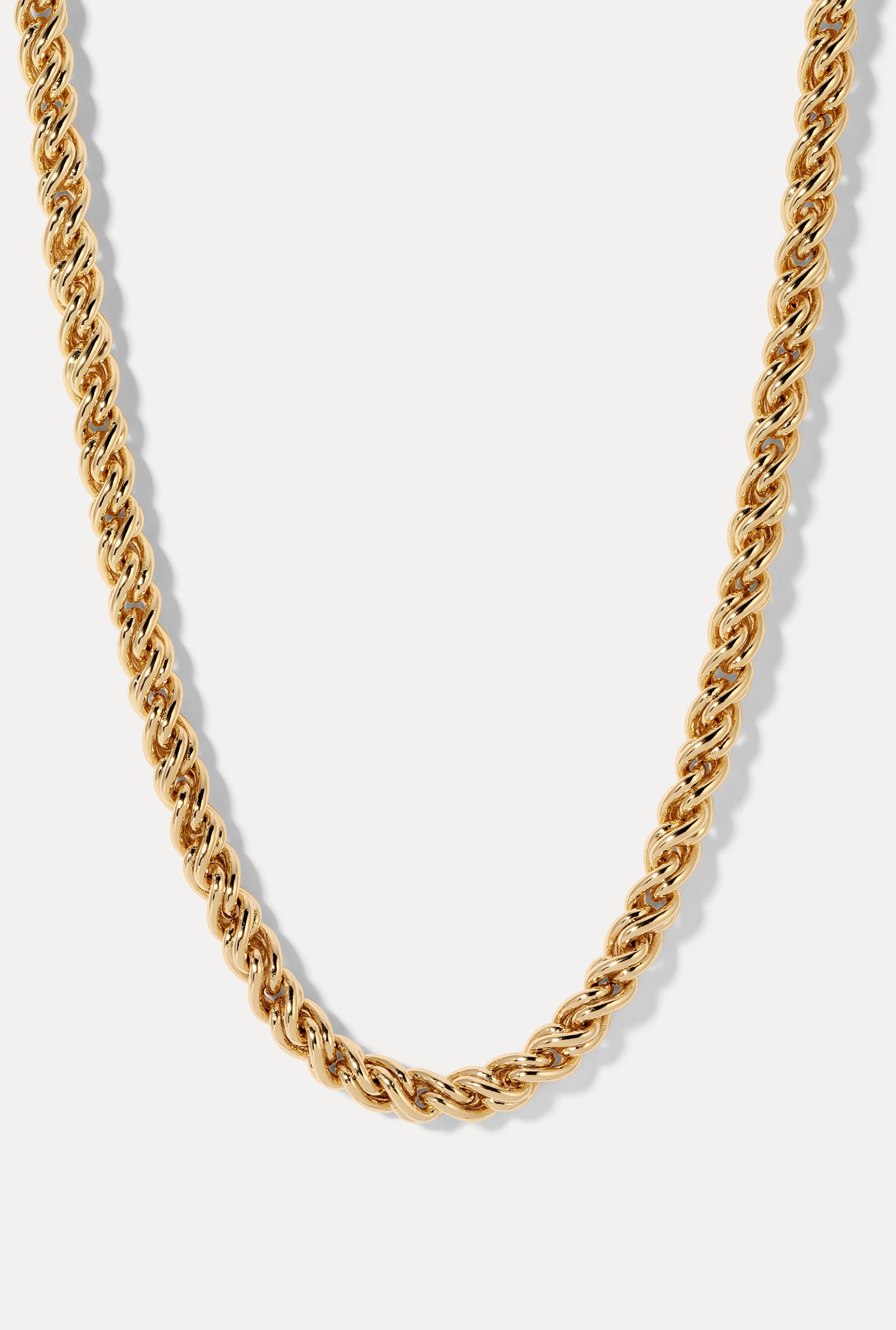 Adriana Gold Rope Chain Necklace draped vertically against a plain white background, showing the detail of the 6mm gold-plated rope chain links.