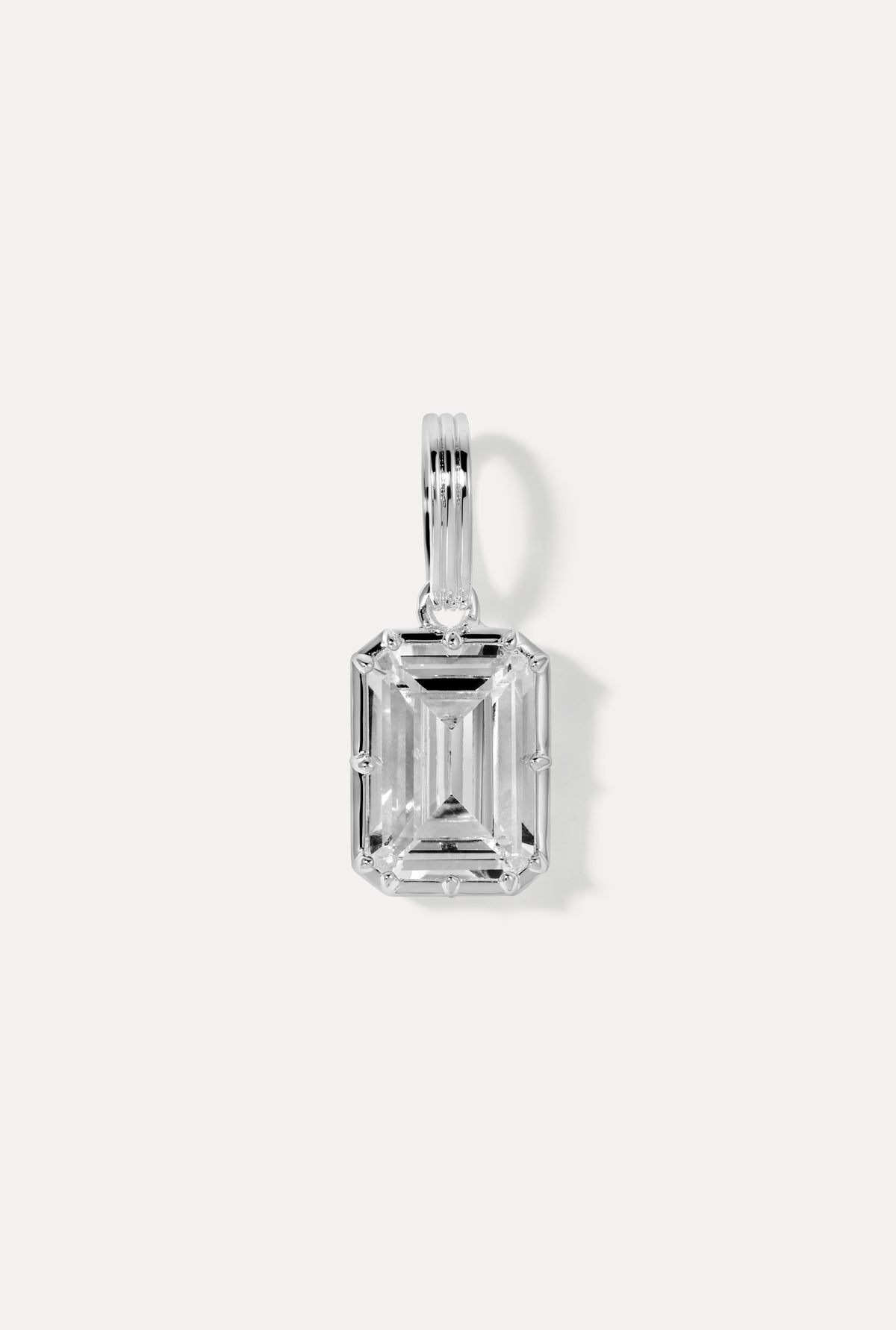 Silver emerald-cut Allure Charm set in sleek sculptural casing flat lay on a white background.