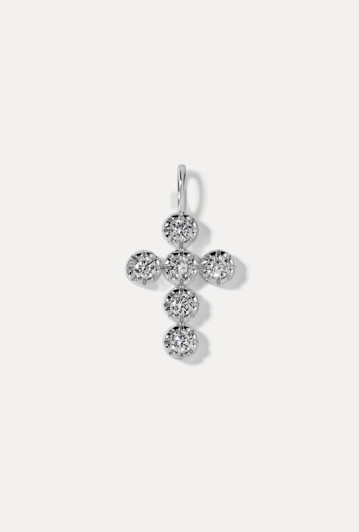 Silver Eternal Charm in a cross shape embellished with round cubic zirconia stones on a white background.