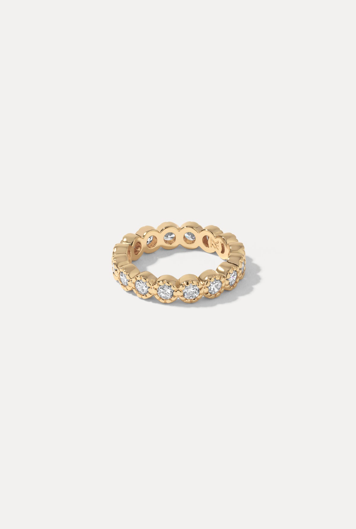Gold Isabelle ring featuring a delicate band and polished finish, centered on a plain white background.