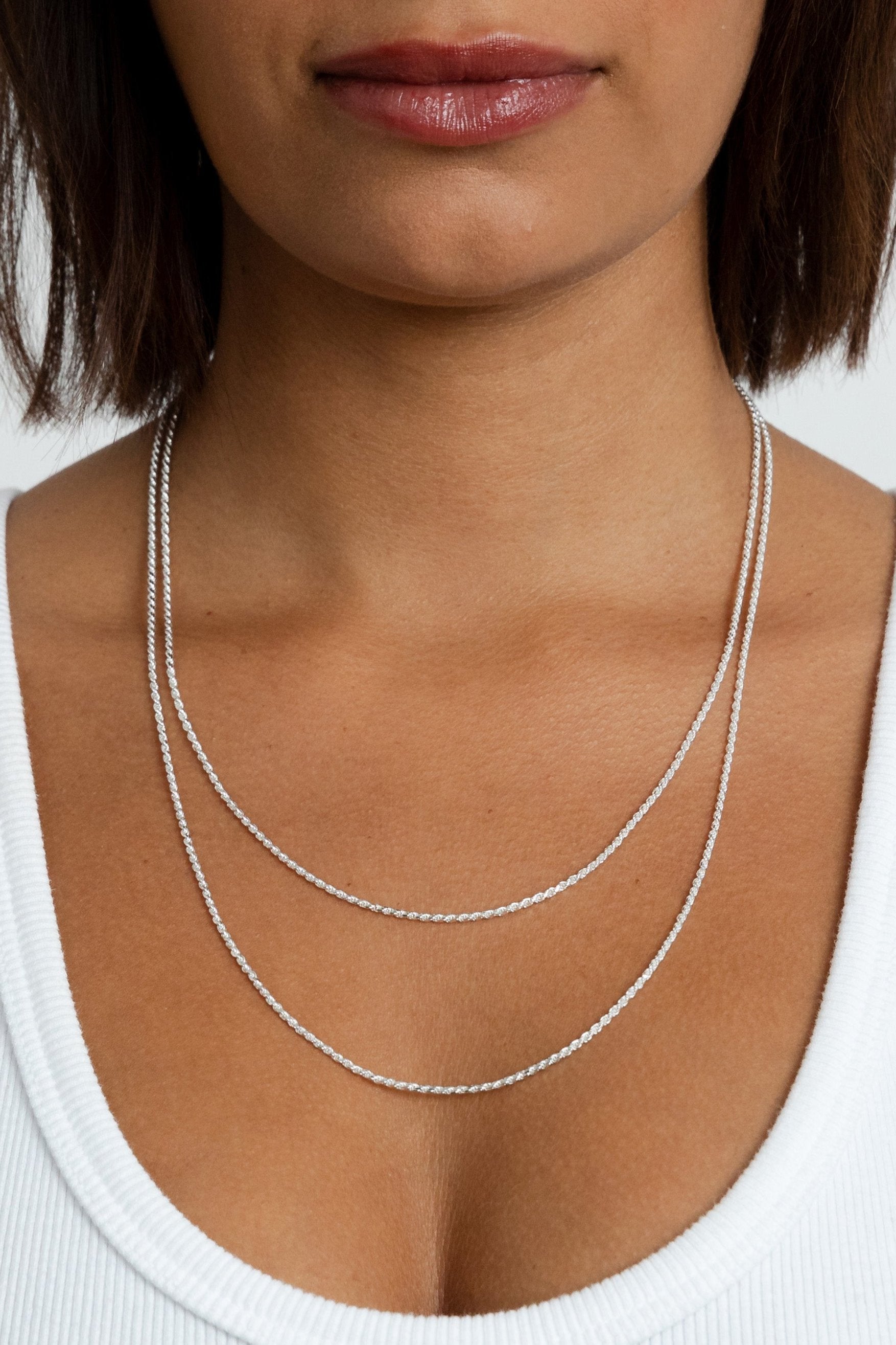 Model wearing two Kate silver rope chains around her neck to showcase different sizes.