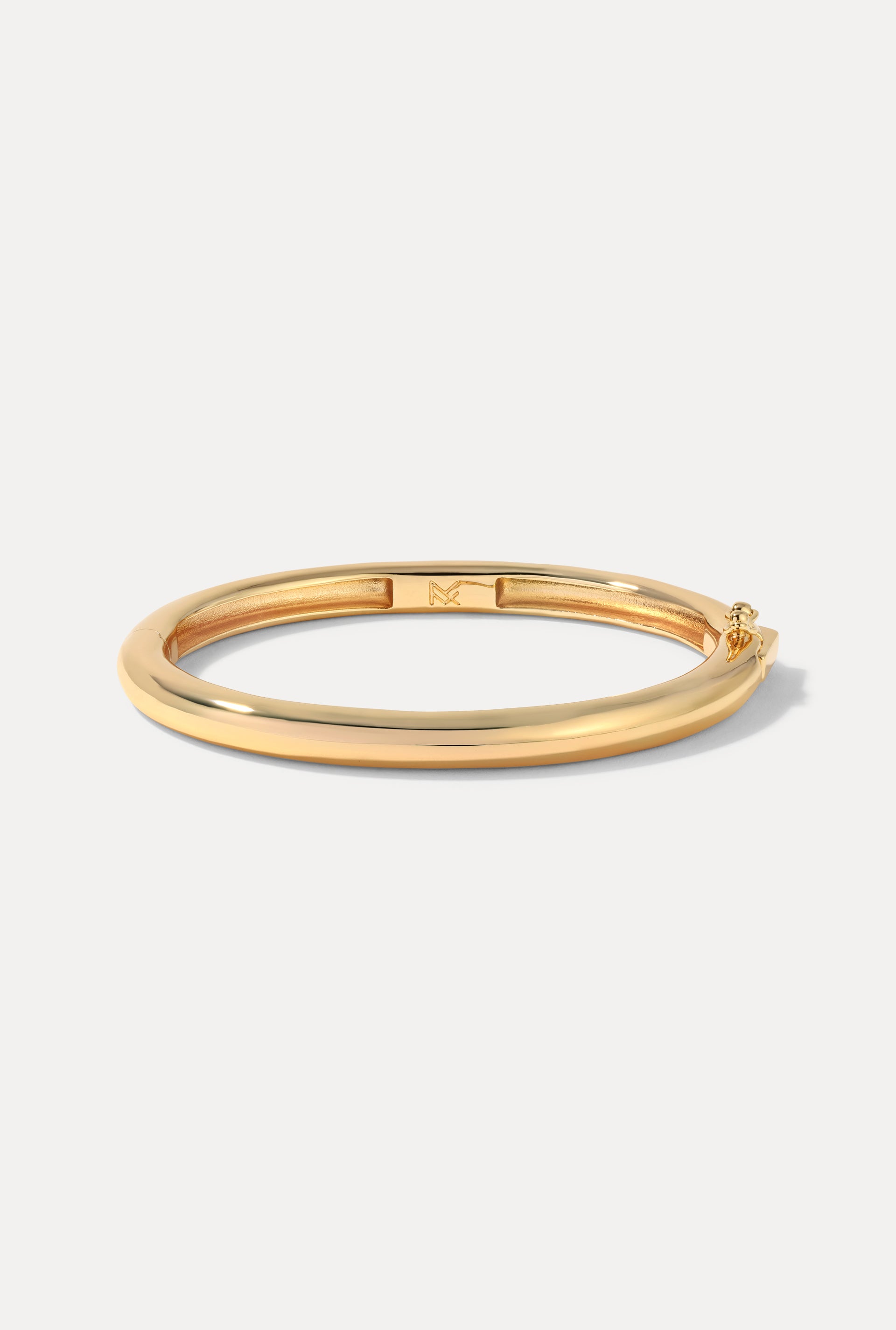 Gold Mina Cuff displayed in an oval shape on a clean white background.