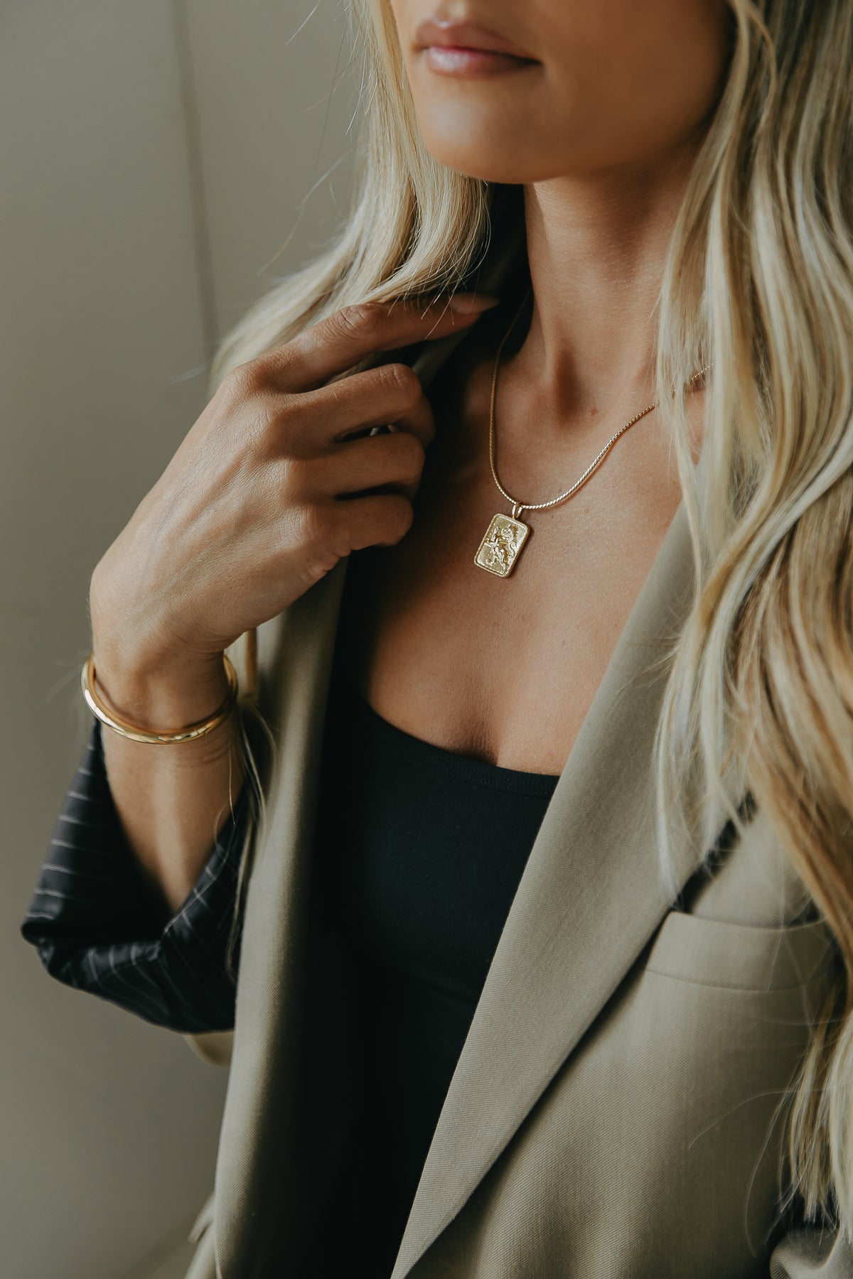 Influencer Mina Zalyashko wearing her namesake gold filled Mina chain with the Lev charm.
