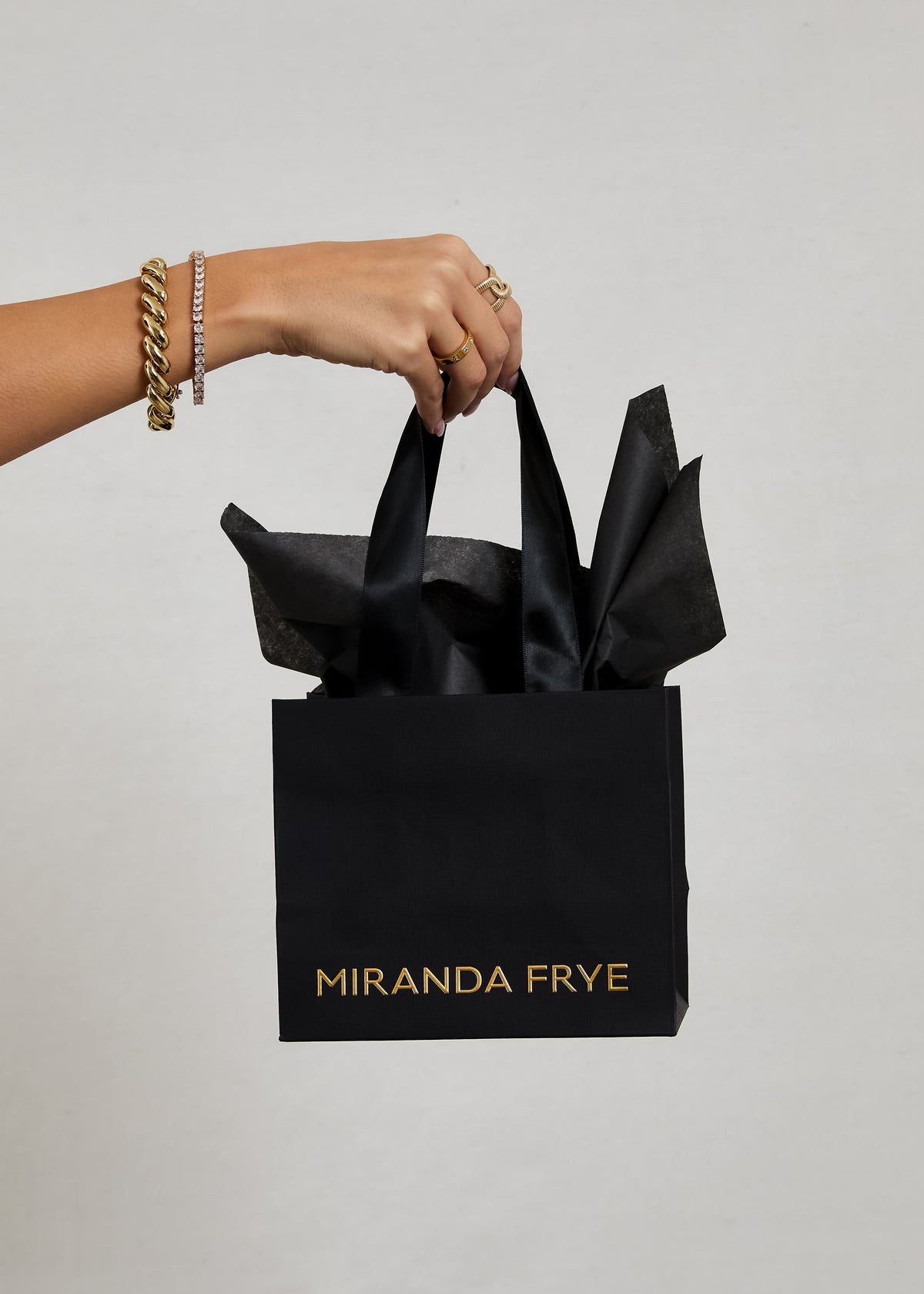 Image of a model holding the Miranda Frye DIY gift wrap kit against a white background.