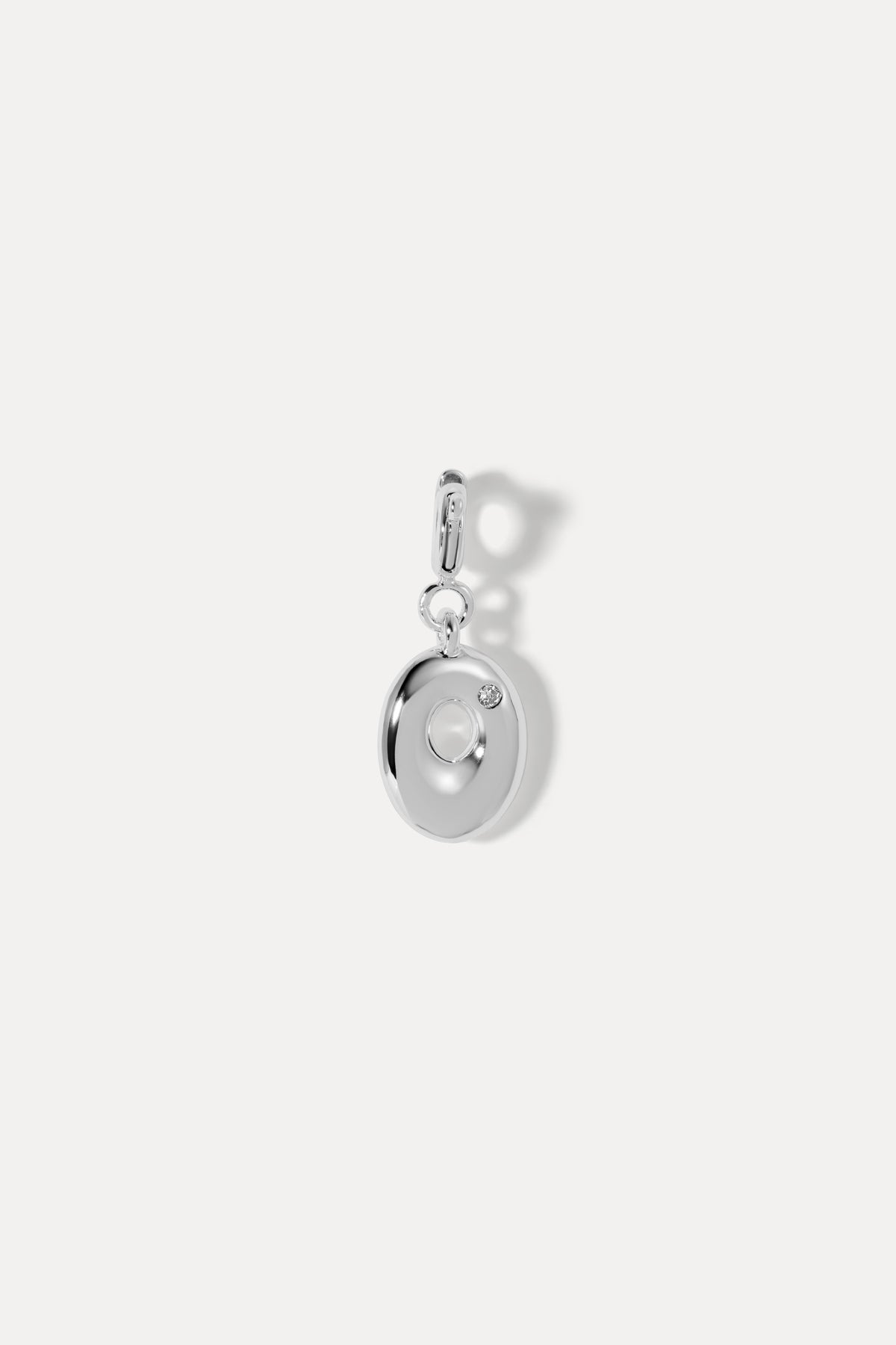 Silver puffy initial clip-on charm in the letter O with a hinged clip bail against a plain white background.