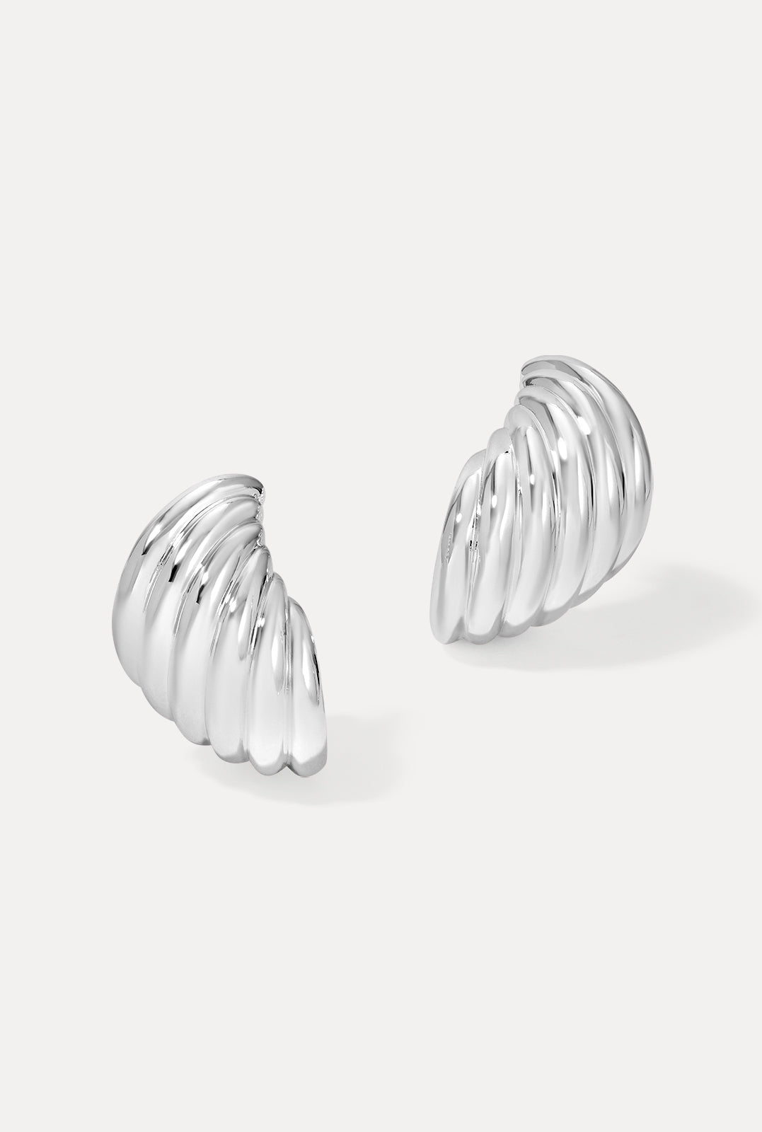 Pair of silver Sirena Earrings featuring a ridged, shell-inspired dome shape on a white background.