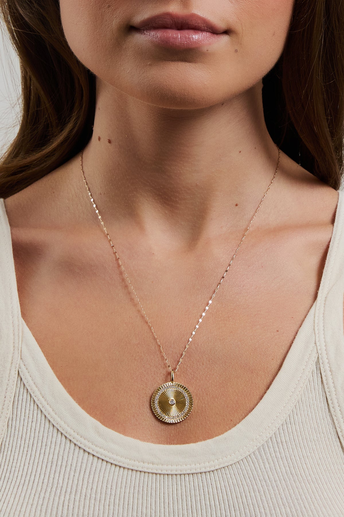 Model wearing gold filled Nora chain with Solara charm and cream ribbed tank