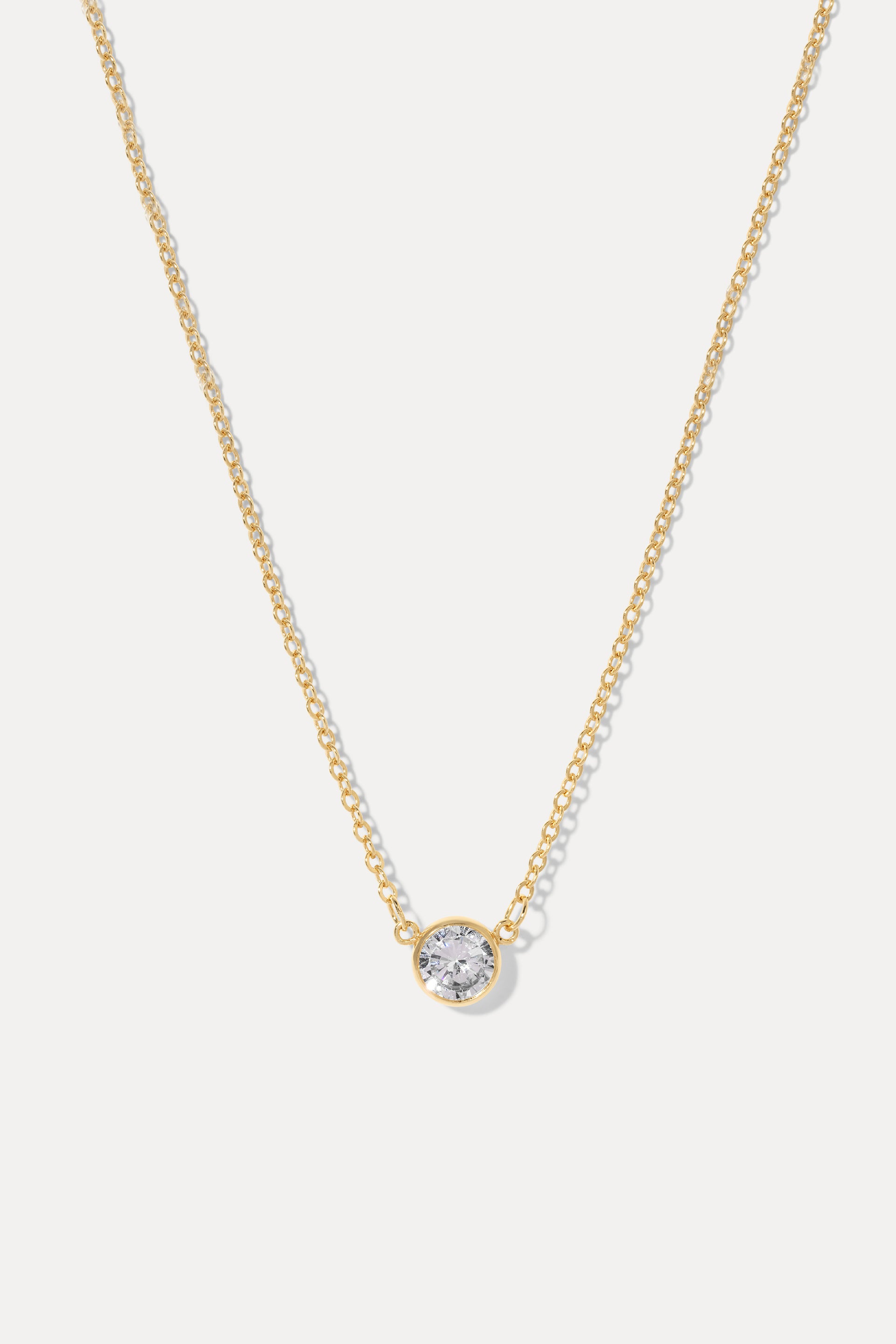 Gold Stephanie necklace with a bezel-set cubic zirconia pendant, displayed on a clean white background.