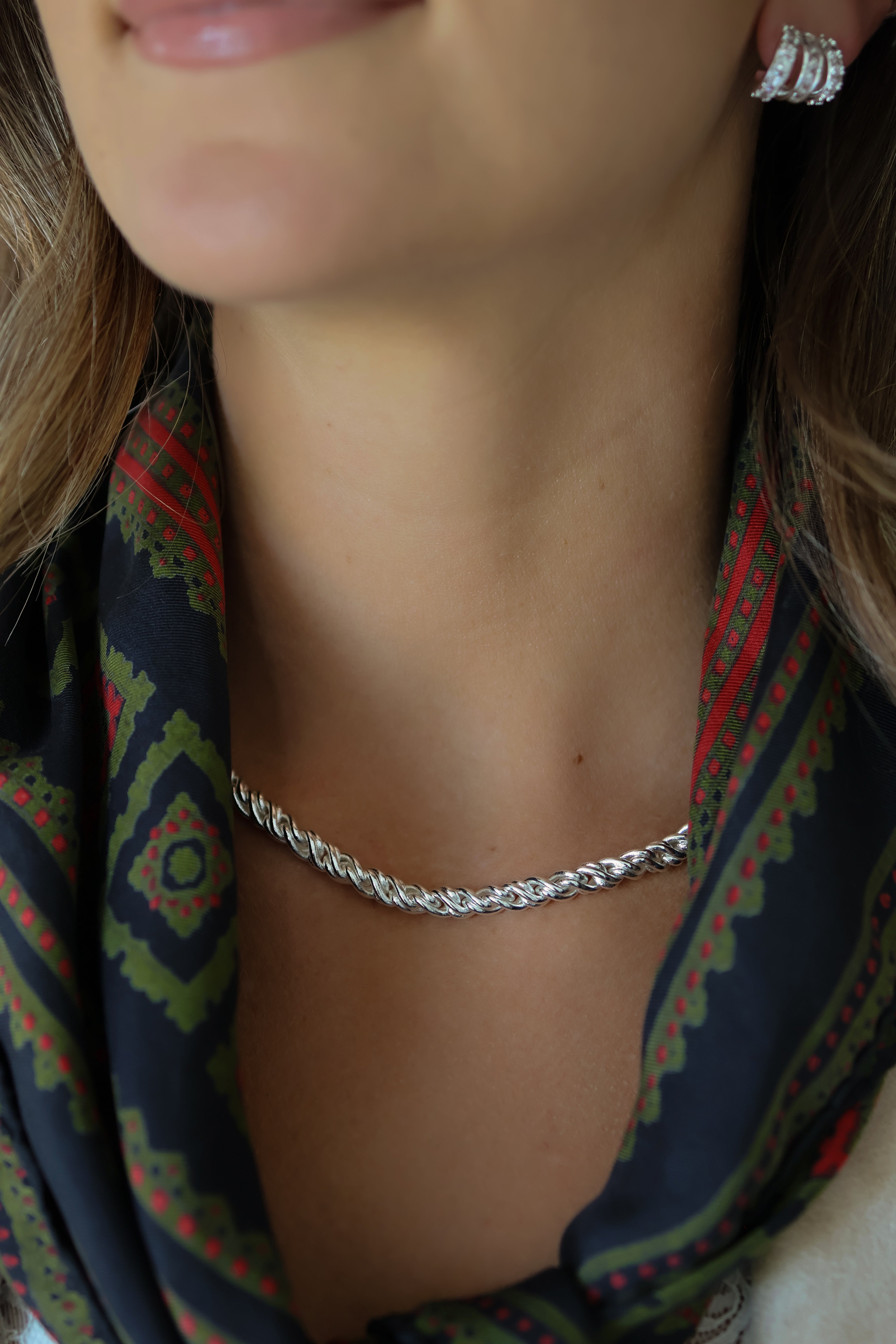 Close-up model photo of a woman wearing the Adriana Silver Rope Chain Necklace.