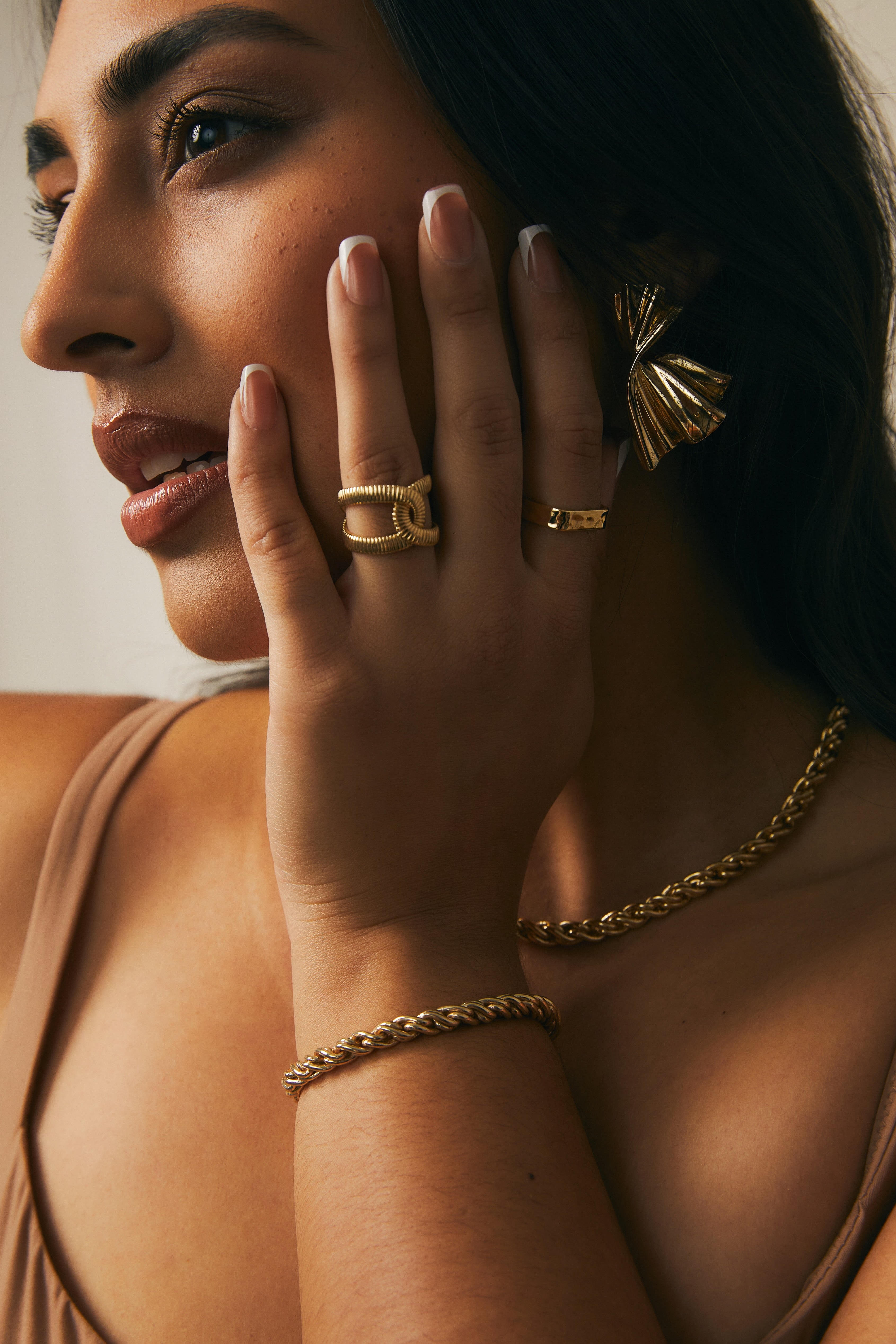 Model photo showing the Adriana Gold Rope Chain Necklace and Bracelet, Monica Earrings, Zoe Ring, worn