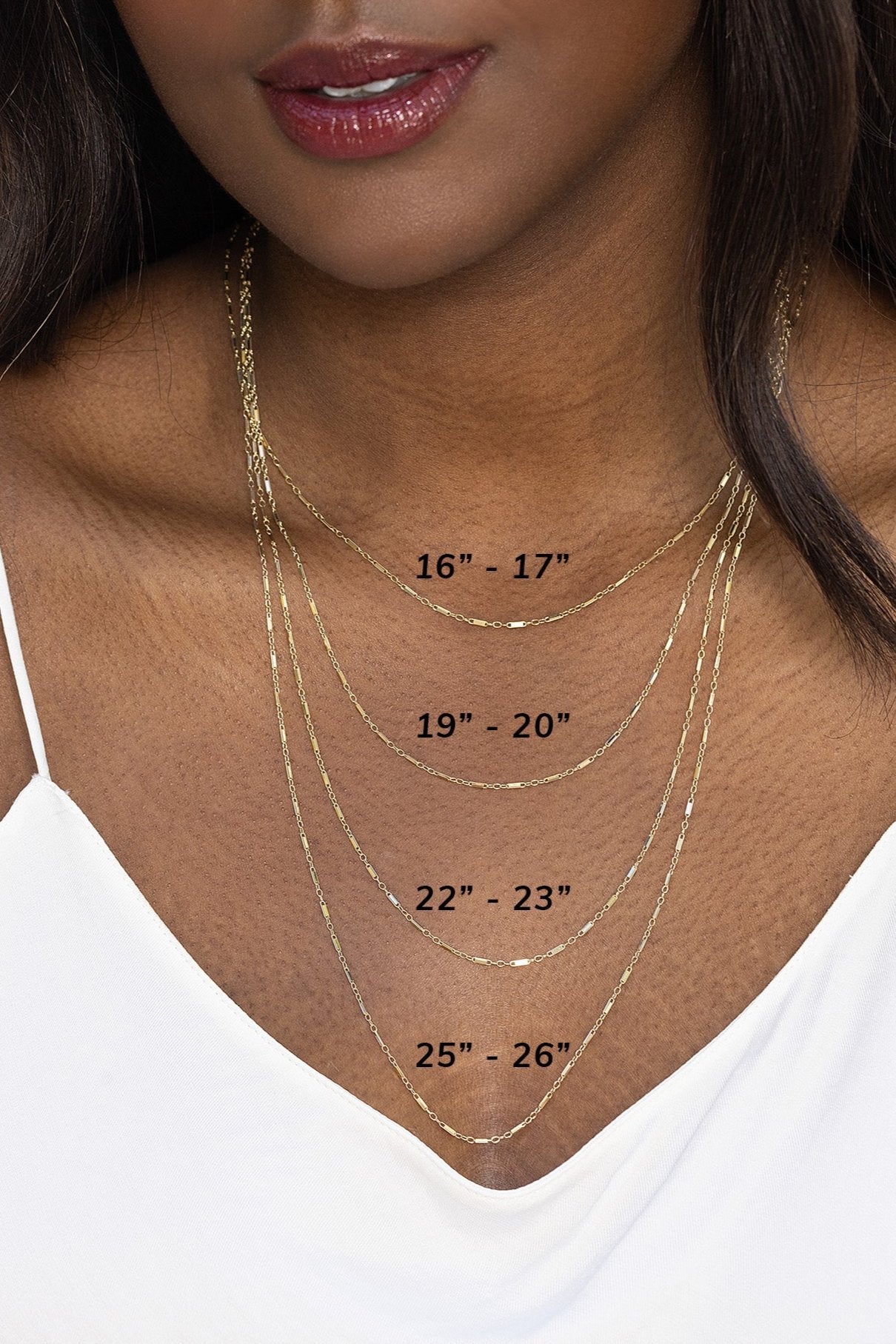 Model wearing the lindsey chain in gold showcasing four distinct lengths.