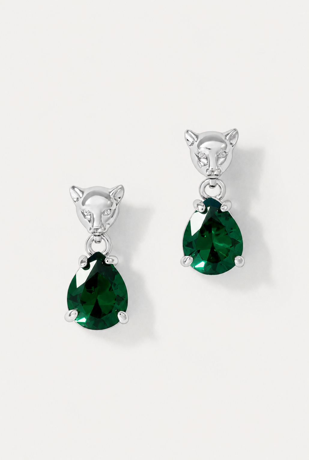 Pair of silver Panther Emerald drop earrings featuring sculpted panther studs and green teardrop gems on white background.