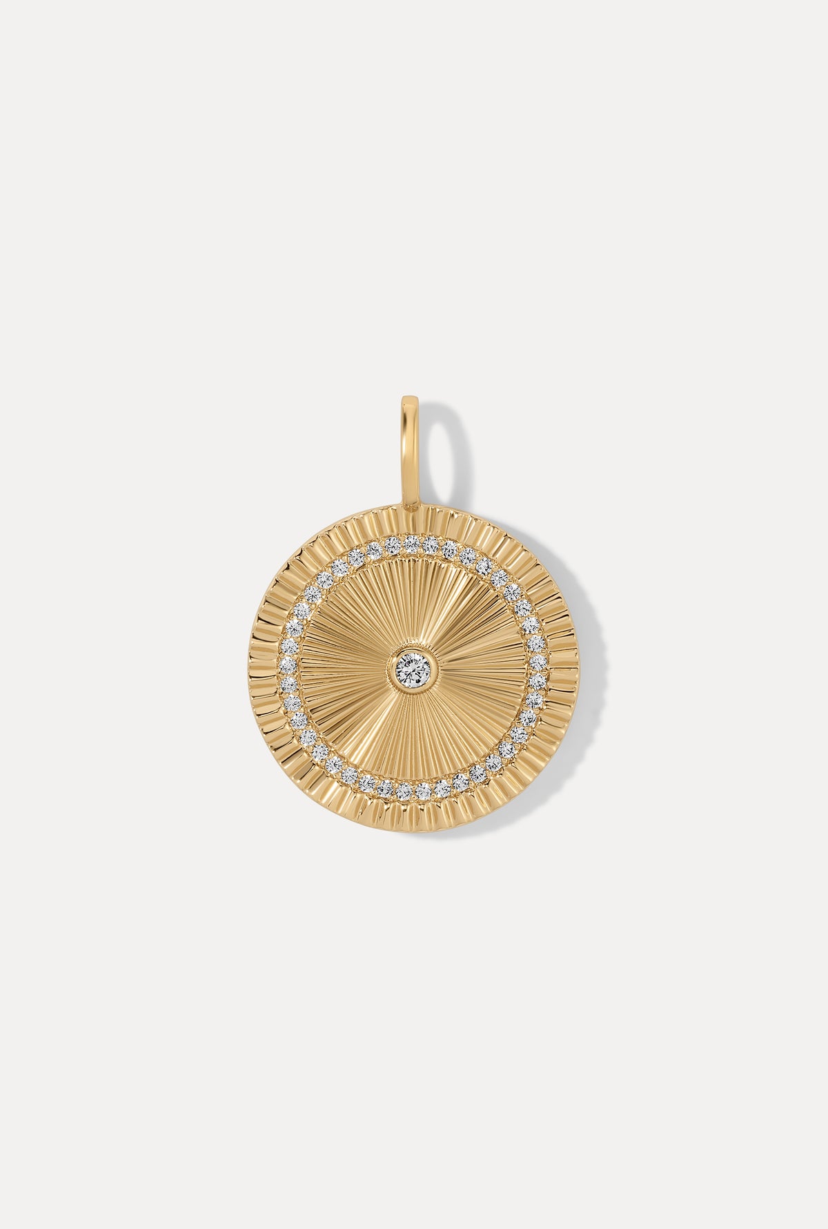 Gold Solara Charm medallion featuring a sunburst design with CZ accents on a white background