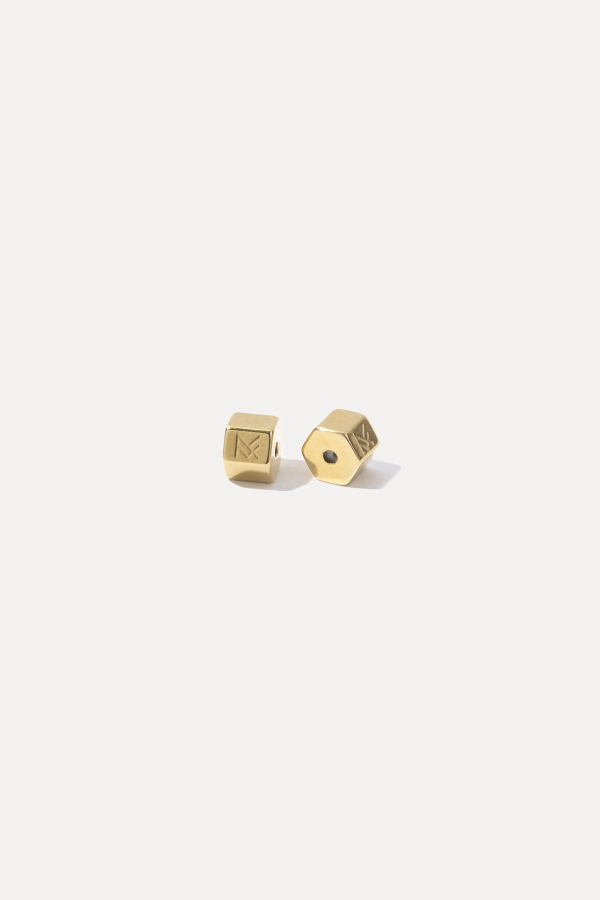 Pair of gold bullet earring backs displayed on a white background.