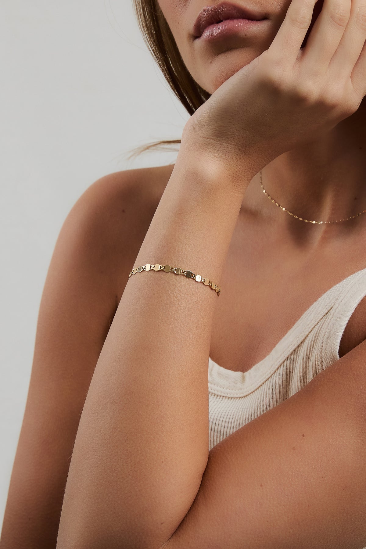 Model wearing gold Ava bracelet and gold filled Nora chain