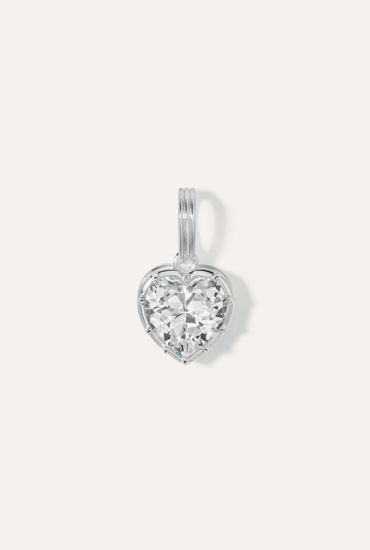 Silver Cheri Charm featuring a heart silhouette with a faceted cubic zirconia on a white background.