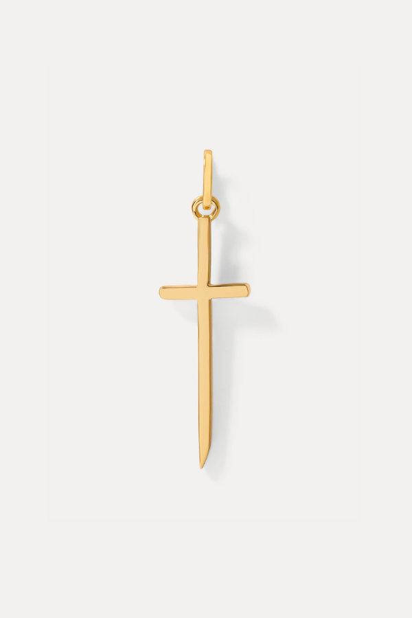Gold slender cross charm on a bail against a plain white background.