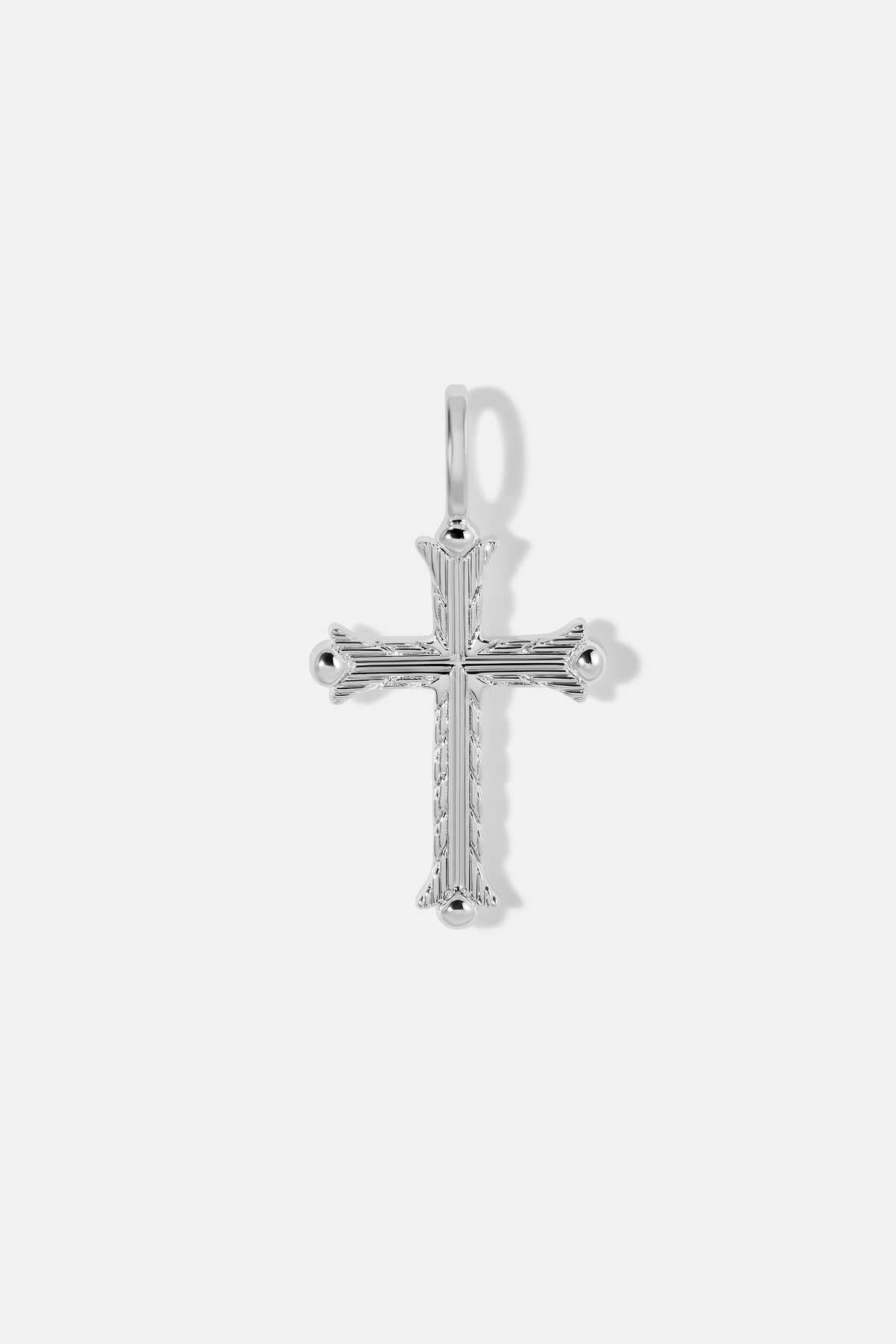 Silver Faith Charm with intricate linear engravings and textured cross details on a white background.
