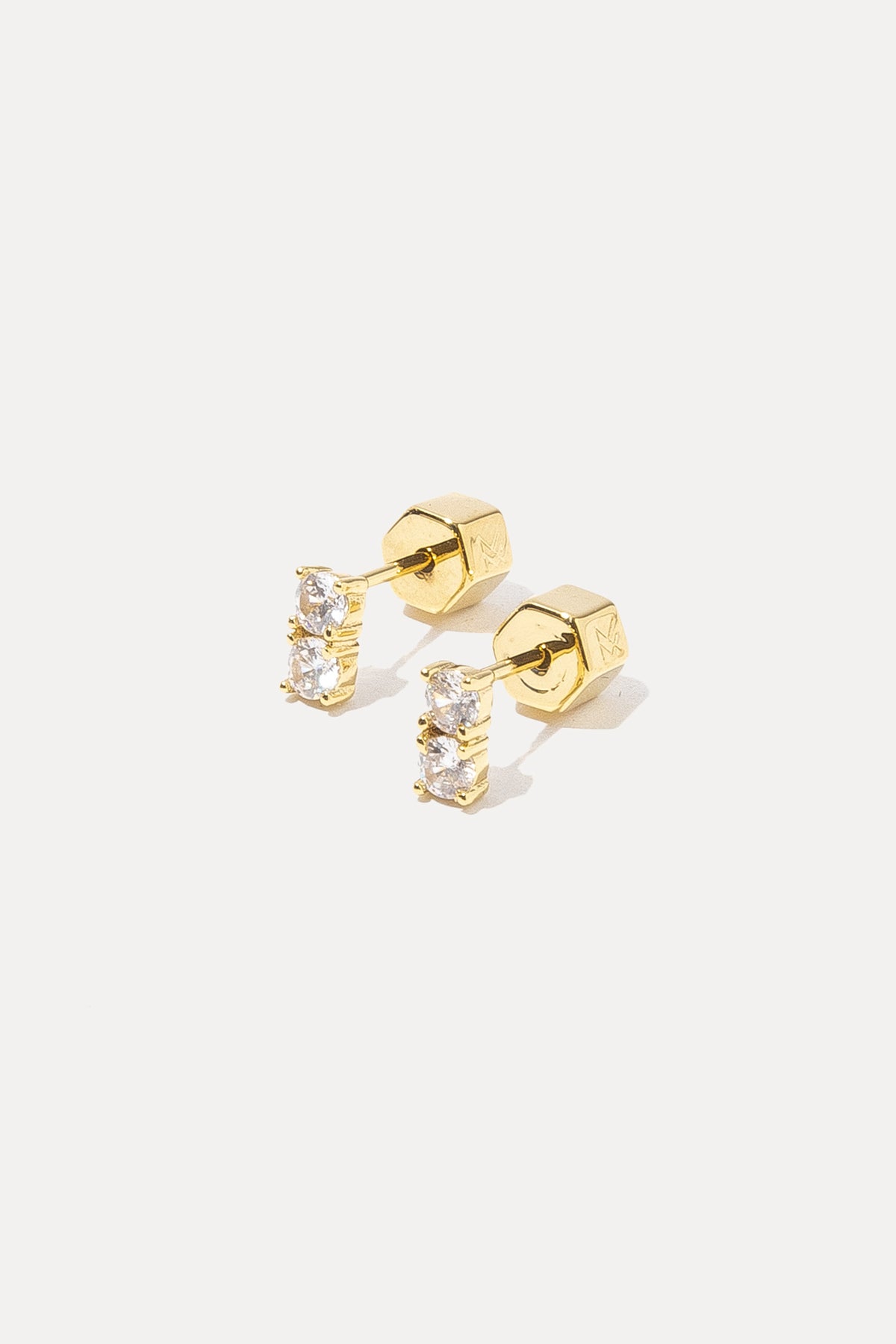 Pair of gold Gwen Studs with clear crystals displayed on a white background.