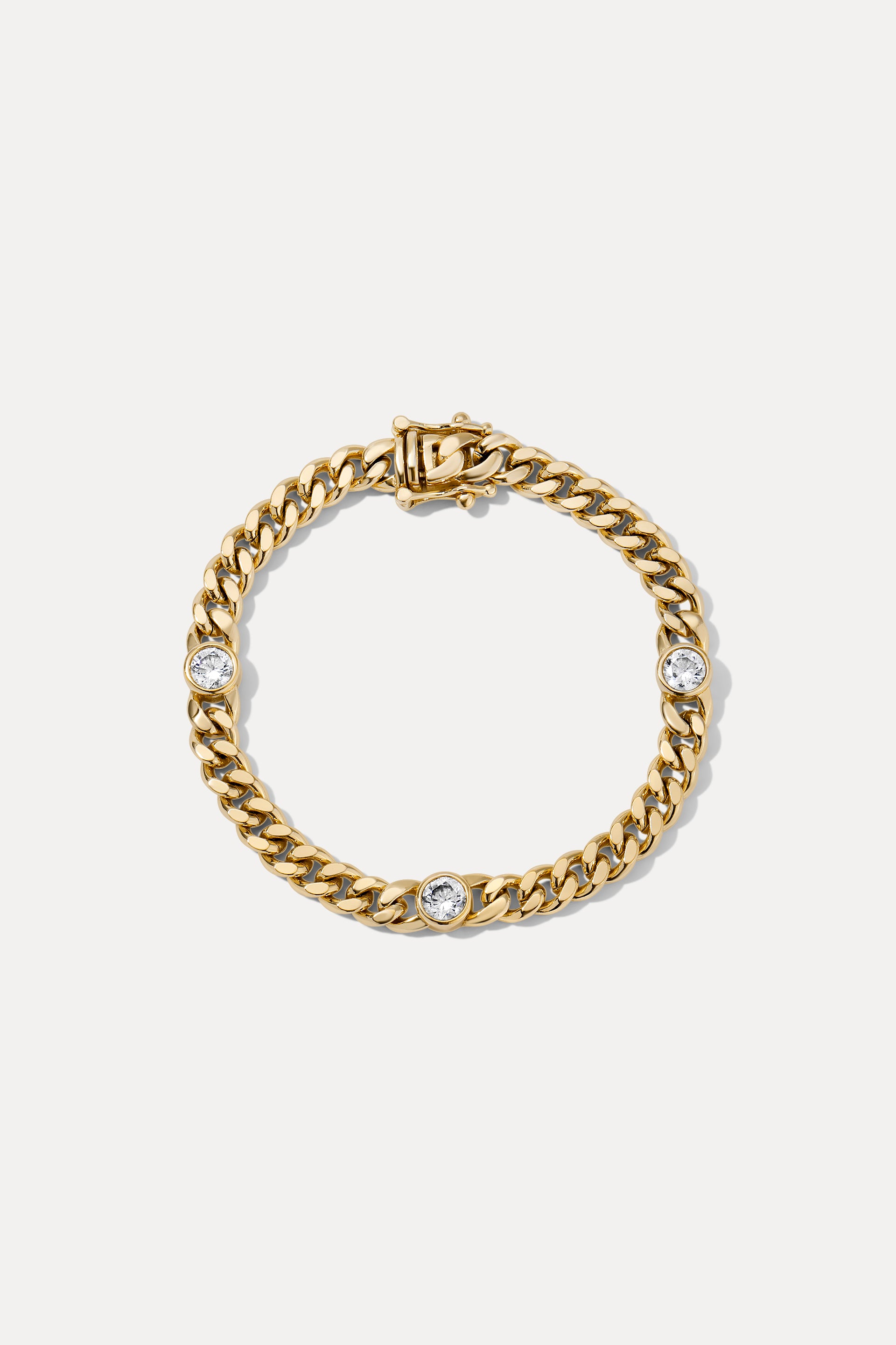 Gold Josie curb chain bracelet with bezel-set CZ stones displayed in a circle on a white background.