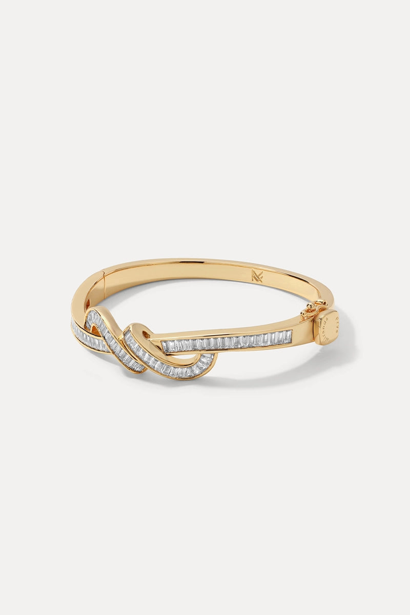 Gold Lana Cuff with channel-set baguette CZ stones displayed in a loop on a white background.