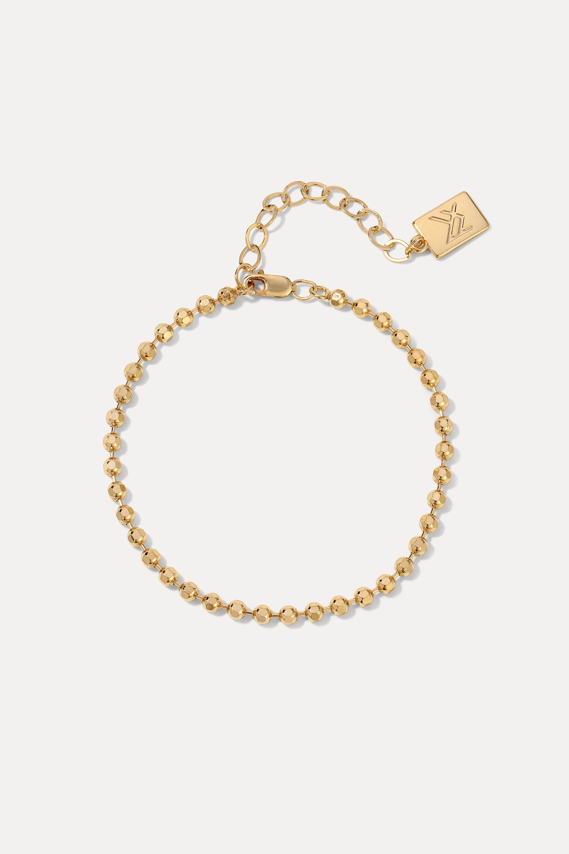 Gold London ball chain bracelet with diamond-cut beads displayed in a circle on a plain white background.