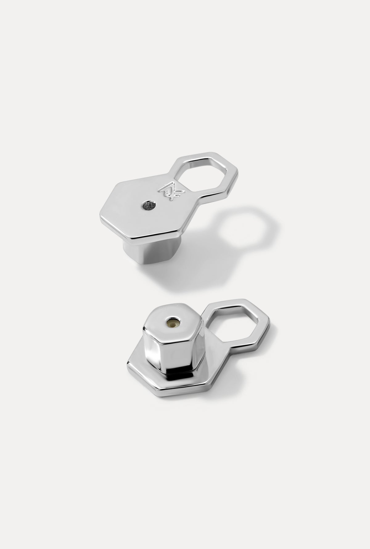 Image of the MF support earring backs in silver on a white background.