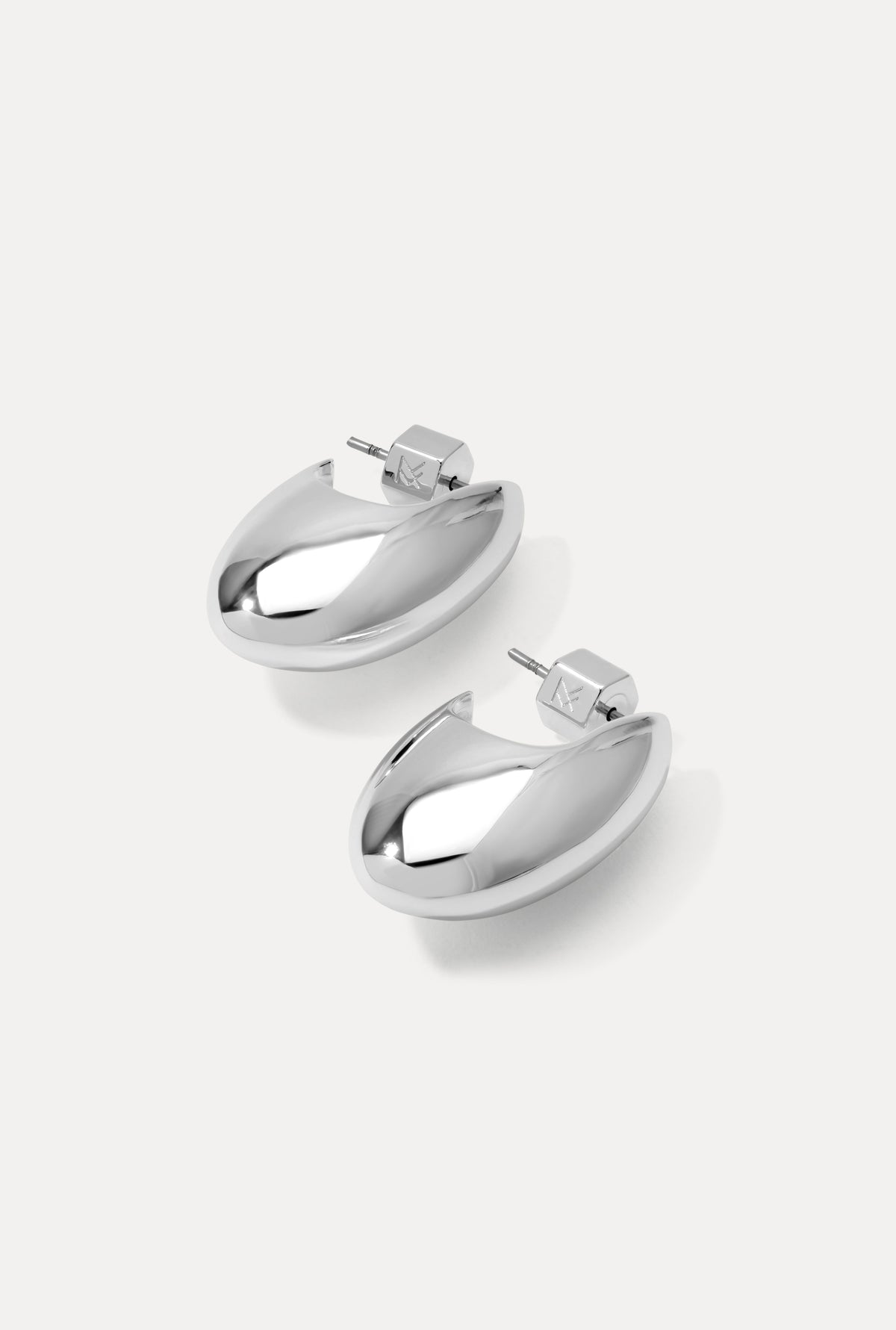 Pair of silver Margot Earrings featuring a chunky, sculpted design on a white background.