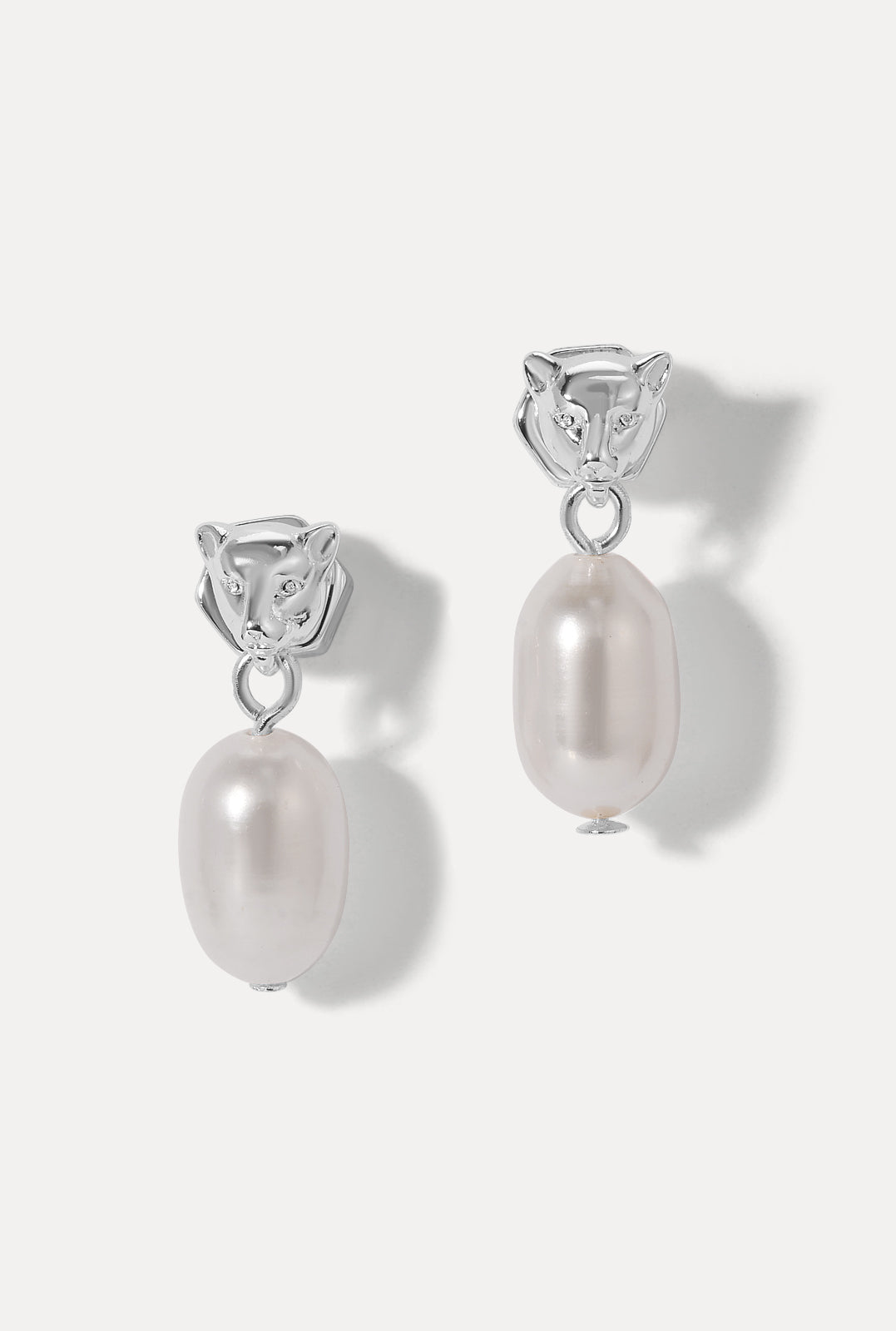 Pair of silver Panther Pearl Earrings with panther heads and dangling pearls on a white background.
