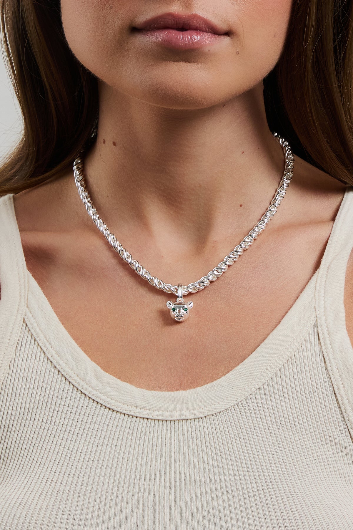 Model wearing silver Panther Charm on adriana necklace, styled with a cream ribbed tank.