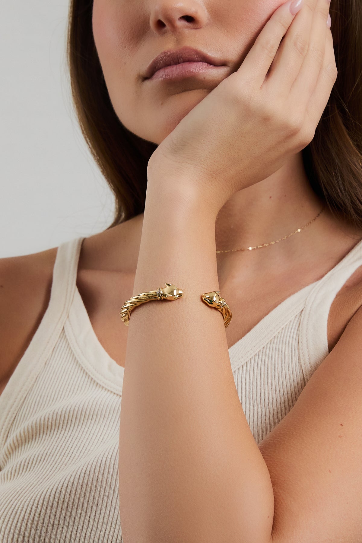Model wearing gold Panther Cuff bracelet and nora chain with cream ribbed tank