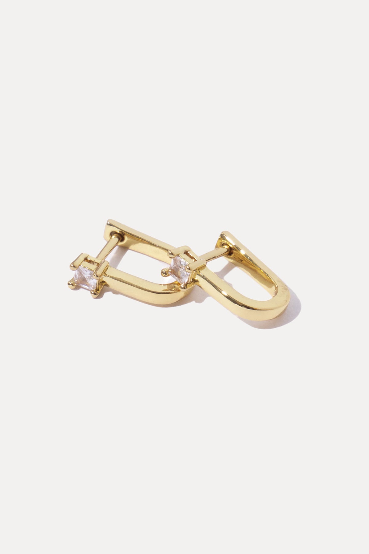 Pair of gold Valentina Huggies featuring clear cubic zirconia drop accents on a white background.