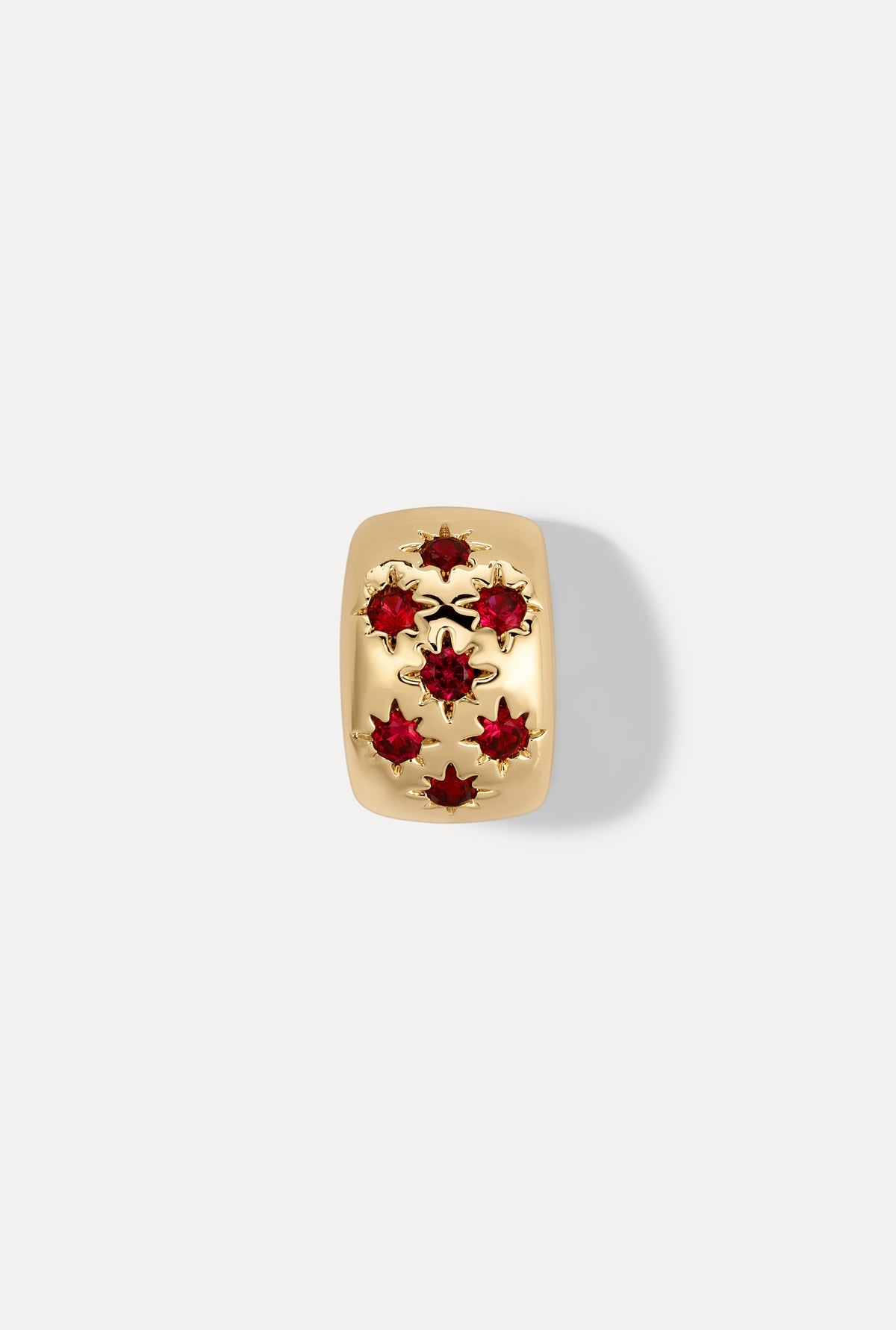 Gold Celeste slider charm with sparkling ruby stones on white background