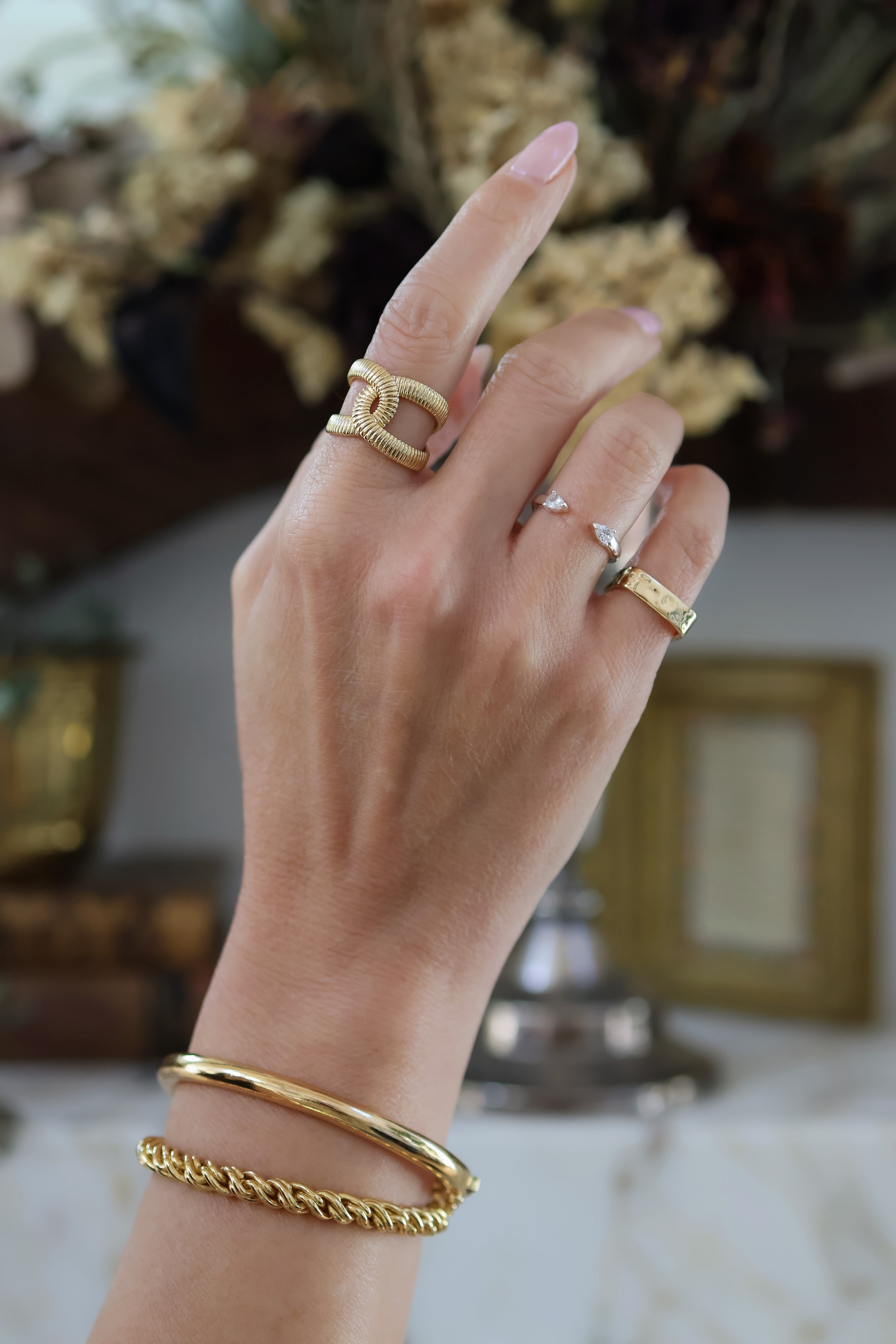 Model wearing the Adriana Gold Rope Chain Bracelet and Mina Bracelet paired with the Zoe, Lyra, and Mae Rings. 