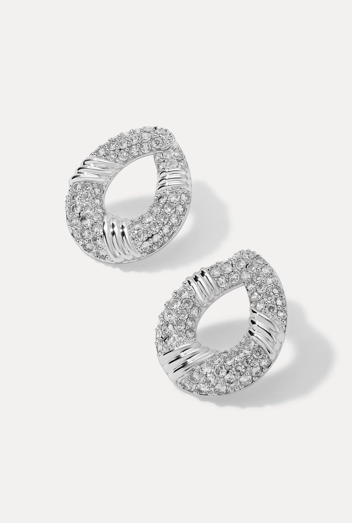 Pair of silver Halle hoop earrings with pavé CZ accents displayed on a white backdrop
