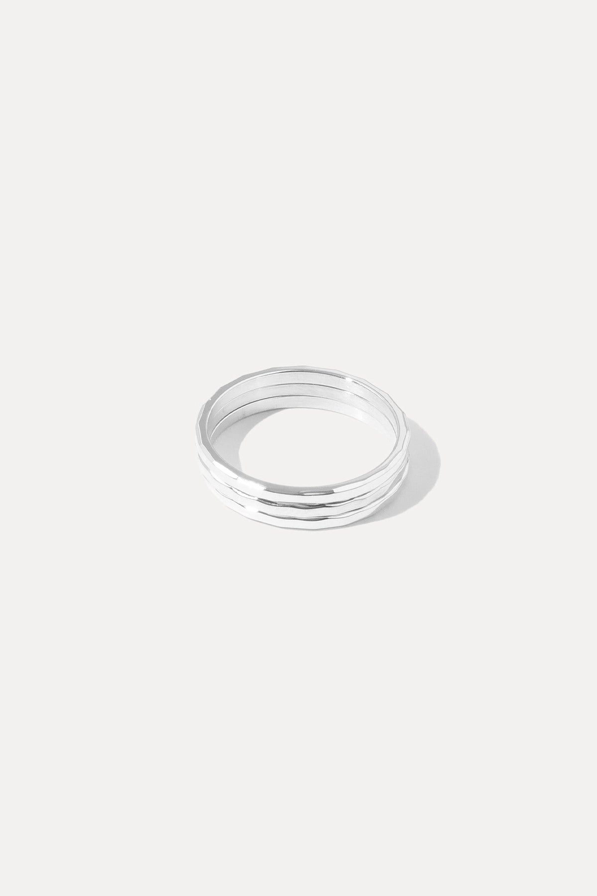 Silver Hazel Stacking Rings set featuring three slim hammered bands displayed on a white background.