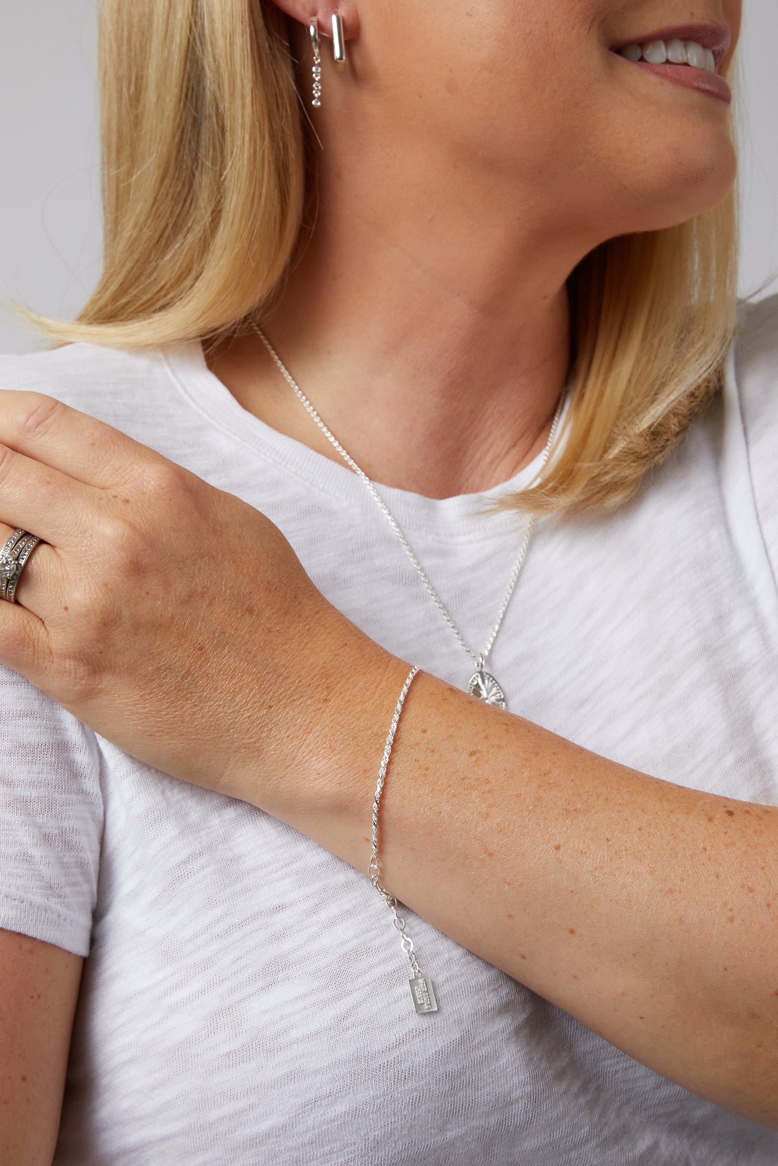 Influencer Kate Bryan wearing the Kate bracelet in Sterling silver on top of a white blouse.