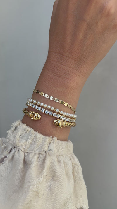 Video of a model slowly moving her wrist wearing the panther cuff, Ava, Bette and Audrey, bracelets in gold. 
