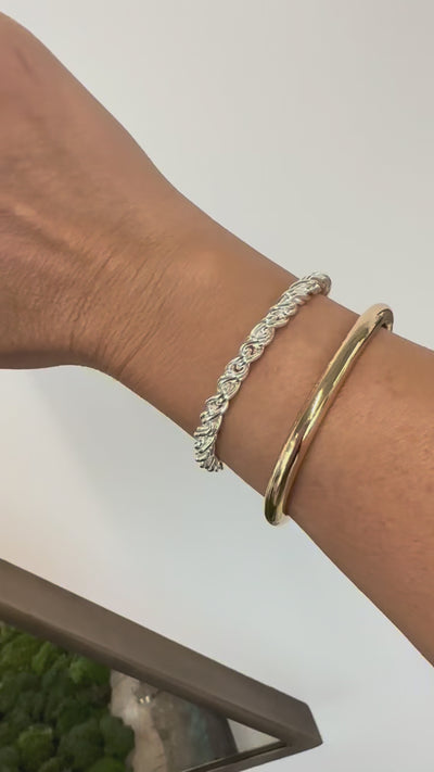 Video of a model wearing the silver Adriana bracelet and the gold Mina cuff.