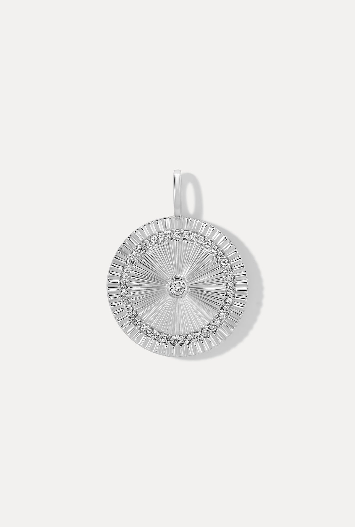 Silver Solara Charm medallion featuring a sunburst design with CZ accents on a white background