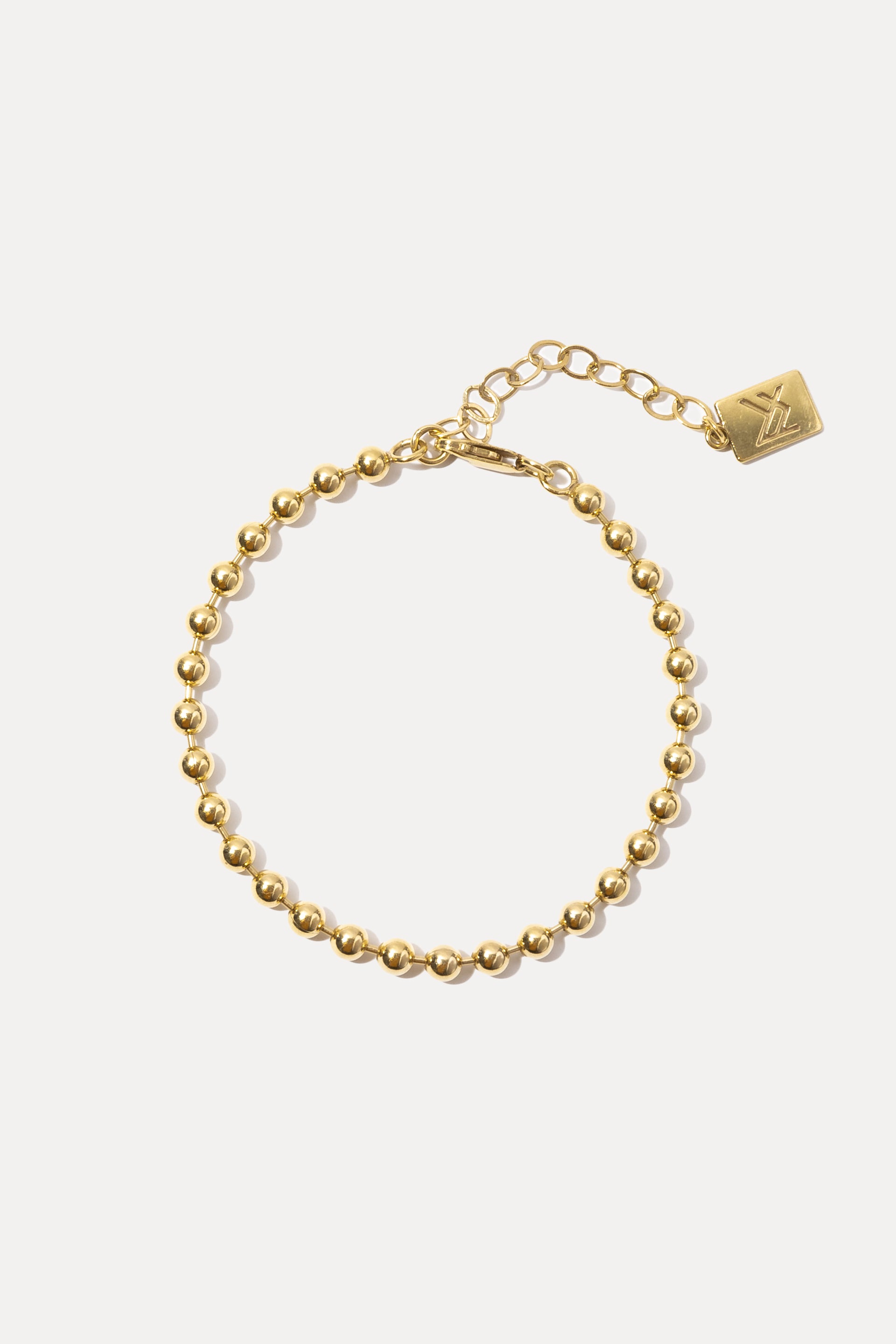 Gold Fashion Jackson Bracelet displayed in a circle on a white background with extender and logo tag.